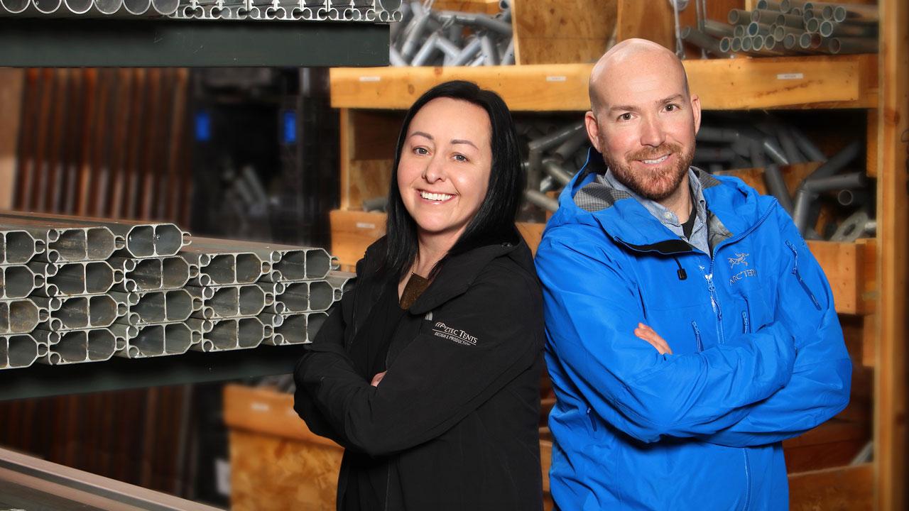 Kelly & Shaun posing in their tent warehouse