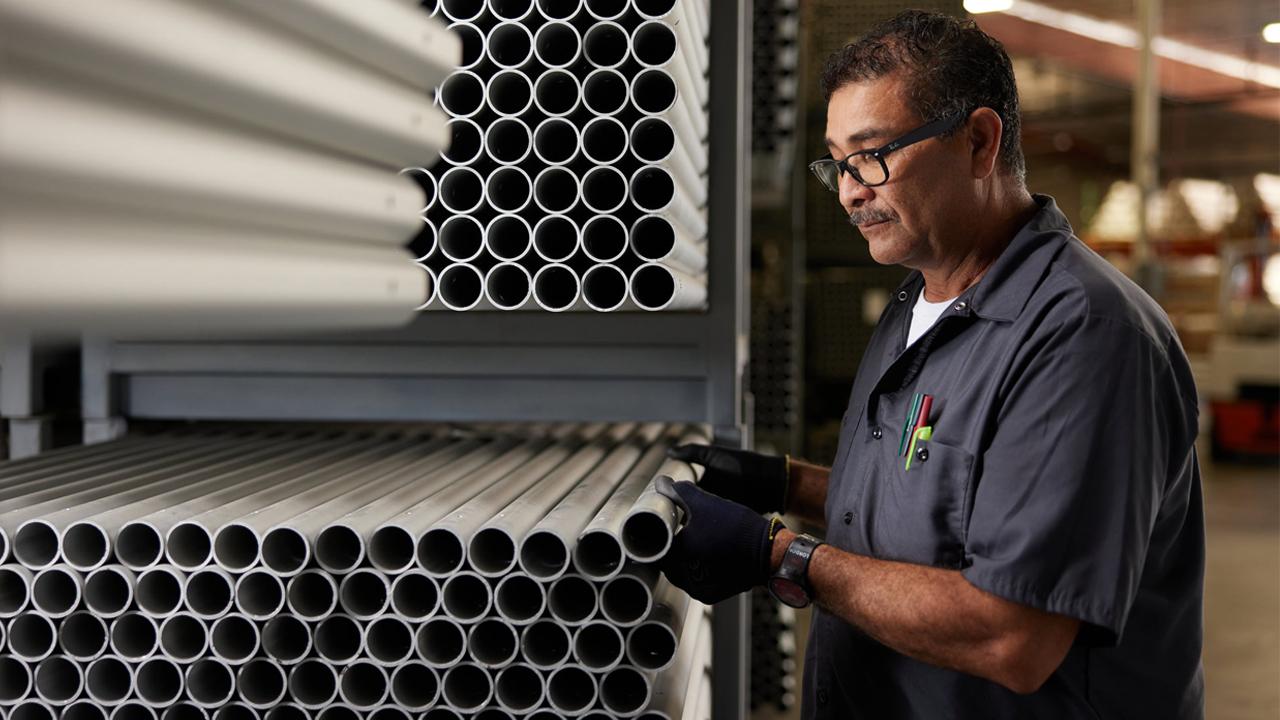 Worker examining pipe